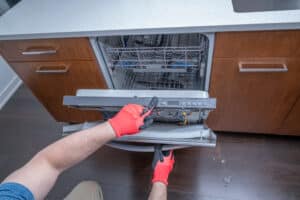 plumber inspecting dish washer