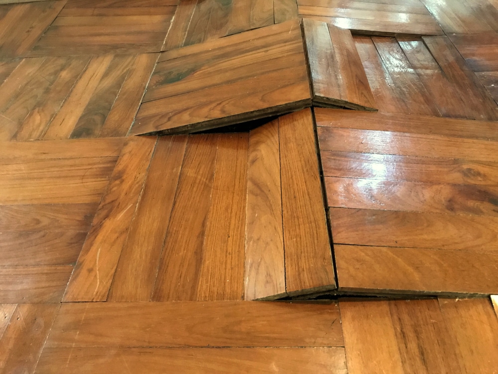 Damaged,Parquet,Floor,Because,Of,Humidity,And,Moisture,,Bending,And Warped floors