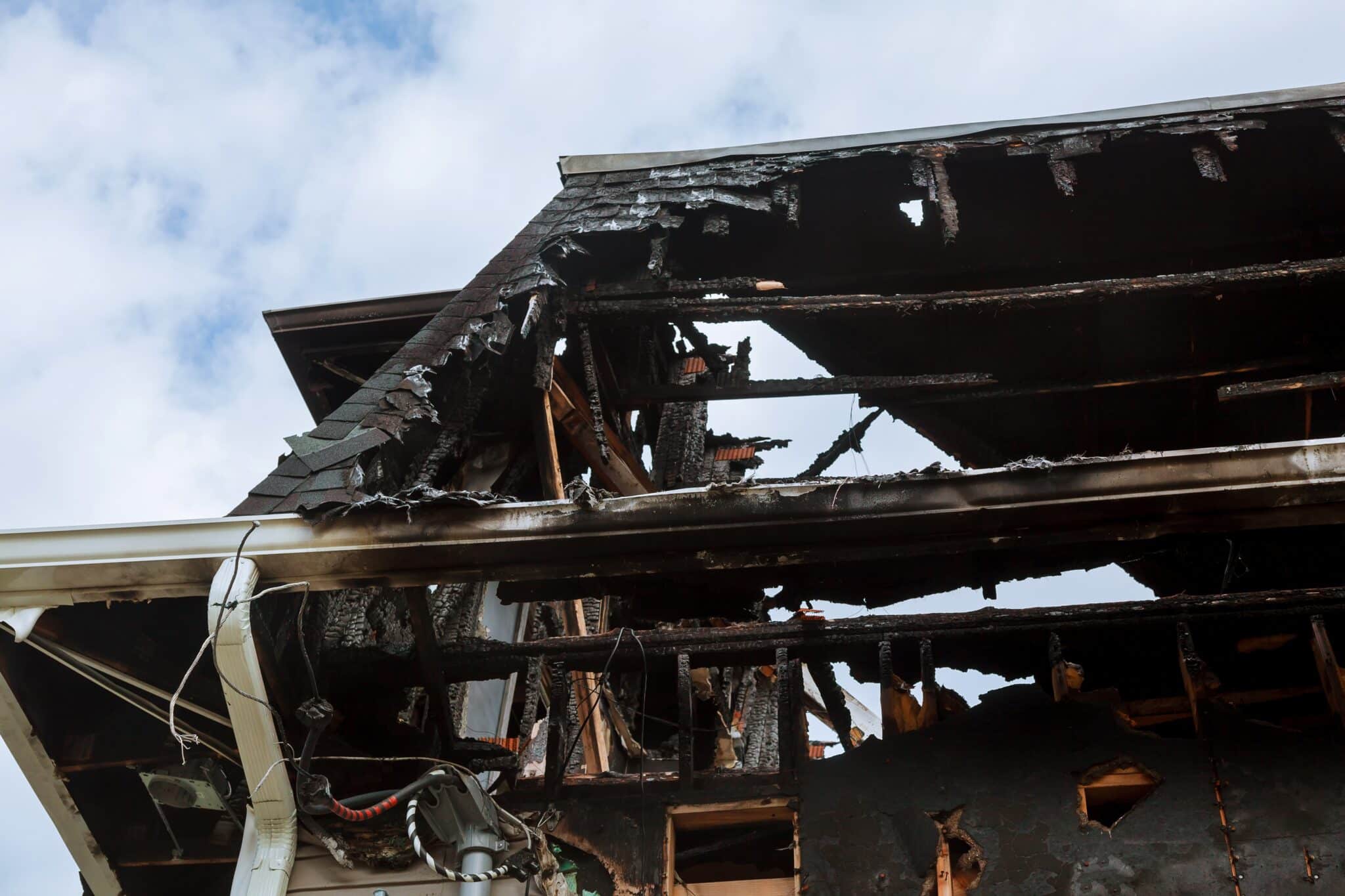 Burnt interiors of house after fire. Burned wooden walls fire damage restoration